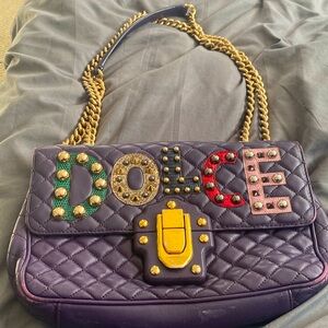 Dolce & Gabbana purple leather shoulder handbag with double gold chain strap .